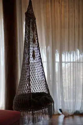 a net hammock sitting in front of a window at Sealord Naithon Beachfront Villa in Nai Thon Beach