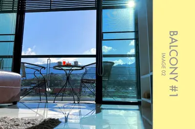 a balcony with a table and a view of the city at Tranquil Condo close to Beach in Kamala Beach