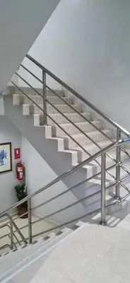 a staircase in a house with a metal railing at ก้านกล้วยแมนชั่น Gankluy Mansion in Phuket Town