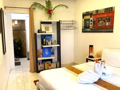 a bedroom with a bed and a book shelf at OASIS VILLA Karon Beach in Karon Beach