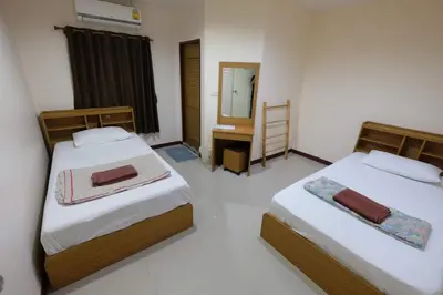 two beds in a room with a mirror at Phi Phi Blue Lagoon in Phi Phi Don