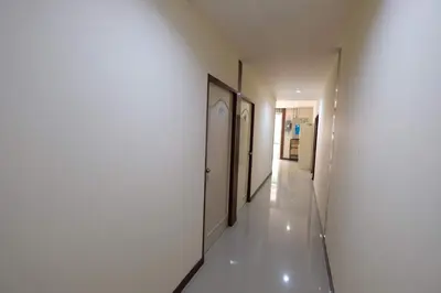 a hallway with white walls and a hallway with two doors at Phi Phi Blue Lagoon in Phi Phi Don
