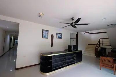 a living room with a ceiling fan and a staircase at Phi Phi Blue Lagoon in Phi Phi Don