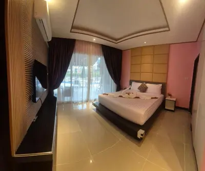 a bedroom with a bed and a large window at La Piccola Kata in Kata Beach