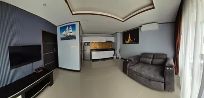 a living room with a couch and a tv at La Piccola Kata in Kata Beach