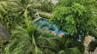 an overhead view of a swimming pool with palm trees at Casuarina Shores Apartment - SHA Plus in Bang Tao Beach