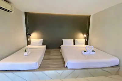 two beds in a room with white pillows on them at The dream garden in Ao Nang Beach