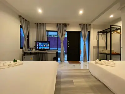 a living room with two beds and a television at The dream garden in Ao Nang Beach