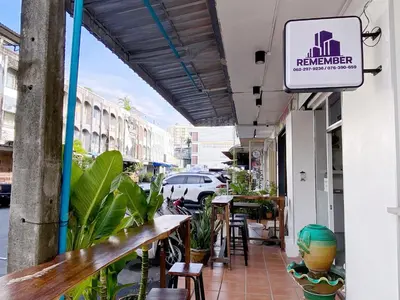 a restaurant with a sign on the side of a building at Remember at Phuket Town Hostel in Phuket Town