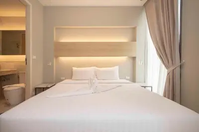 a large white bed in a room with a window at Apartment in Aonang - great location with pool in Ao Nang Beach