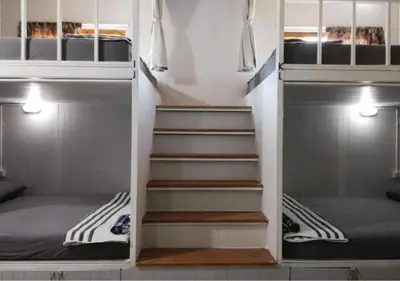 a set of stairs in a room with a bed at Farm House kohyaoyai in Ko Yao Yai