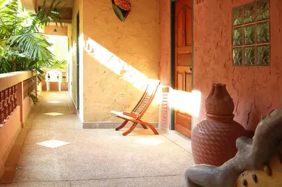a patio with a chair and a vase in a room at Casa Brazil Homestay in Karon Beach
