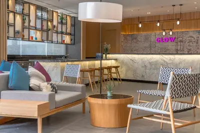 a lobby of a showroom with chairs and a bar at GLOW Mira Karon Beach in Karon Beach