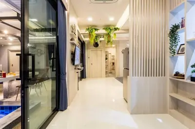 a hallway of a house with a glass door at Nut & Non Pool Villa by Duangtham in Ban Khlong Haeng