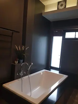 a large white tub in a bathroom with a window at Nut & Non Pool Villa by Duangtham in Ban Khlong Haeng