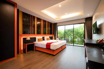 a bedroom with a bed and a large window at WOW PHUKET in Phuket Town