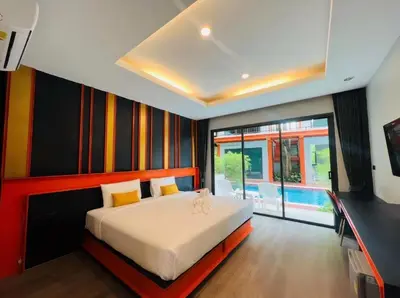 a bedroom with a bed and a swimming pool at WOW PHUKET in Phuket Town