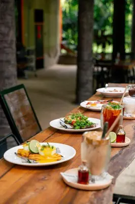 a wooden table with plates of food on it at WOW PHUKET in Phuket Town