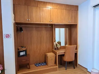 a room with a desk and a table with a chair at The Chic Pool Villa in Nai Yang Beach