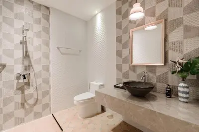 a bathroom with a sink and a toilet and a mirror at Sabai Hotel Aonang in Ao Nang Beach