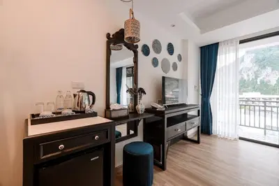a bathroom with a vanity and a sink and a mirror at Sabai Hotel Aonang in Ao Nang Beach