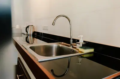 a kitchen sink with a faucet on a counter at Kunna House in Ko Yao Noi