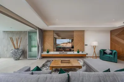 a living room with a couch and a table at Beachfront Residences - Stunning Sea and Lake View in Bang Tao Beach