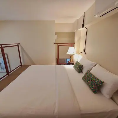 a bedroom with a large white bed with two pillows at Alleyhill Phuket - Private & Cozy Boutique in Phuket Town