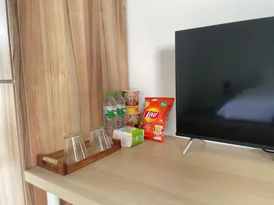 a tv sitting on a table next to a shelf at Alleyhill Phuket - Private & Cozy Boutique in Phuket Town