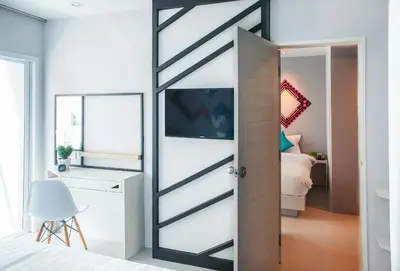 a sliding door in a bedroom with a bed at The Crib Patong - SHA Certified in Patong Beach