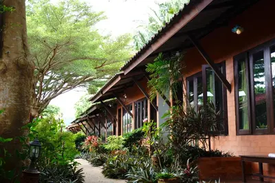 a building with a bunch of plants in front of it at Phuket Siam Villas - SHA PLUS in Chalong