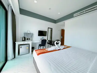 a bedroom with a large bed and a desk at Machorat Aonang Resort at Aonang Beach Krabi in Ao Nang Beach