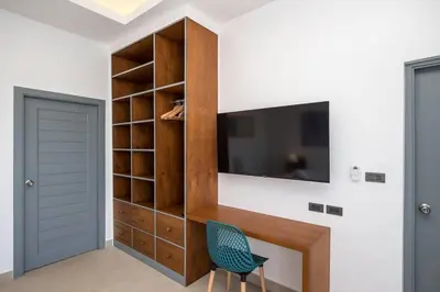 a living room with a tv and a chair at amazing new brand 3 bedrooms pool villa at rawai in Rawai Beach