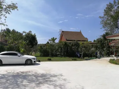 a white car parked in front of a house at The Casita Phuket (SHA+) in Mai Khao Beach