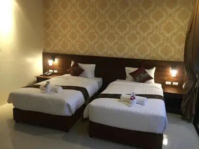 two beds in a hotel room with white sheets at The Casita Phuket (SHA+) in Mai Khao Beach