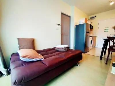 a large brown couch sitting in a living room at Chic & Sweet, Pool view, Prime location near beach in Phuket Town