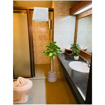 a bathroom with a sink and a toilet and a mirror at Grillhütte Patong in Patong Beach