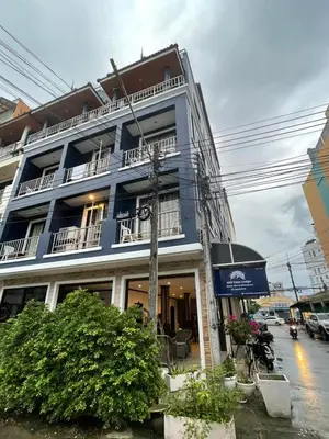 a blue building with balconies on a city street at Hill View Lodge in Patong Beach