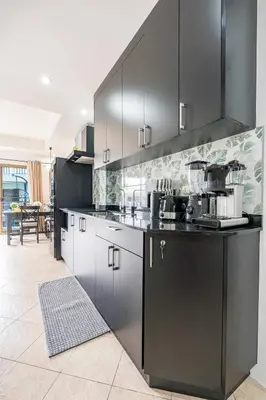 a kitchen with black cabinets and a counter top at Kamala - The Club Residence -2 BR Pool View Residence in Kamala Beach