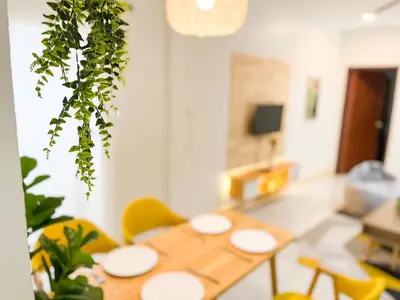 a dining room with a table and yellow chairs at 1BR Cozy House, Bangtao Beach in Ban Thalat Choeng Thale