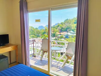 a bedroom with a view of a balcony at Blue View House Phi Phi in Phi Phi Don