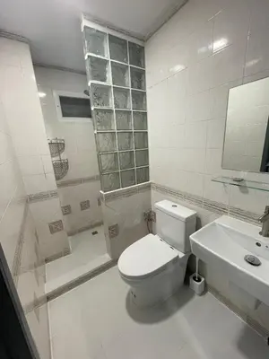 a bathroom with a toilet and a sink and a shower at Garden Beach Sea View Patong in Patong Beach