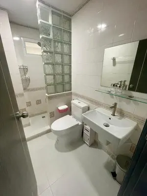 a bathroom with a white toilet and a sink at Garden Beach Sea View Patong in Patong Beach