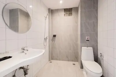 a white bathroom with a sink and a toilet at Moon Budget Hotel in Ao Nang Beach