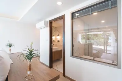 a living room with a large window in a house at seaview villa private swimming pool in Karon Beach