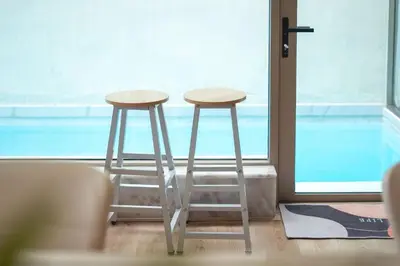 two stools sitting in front of a window at seaview villa private swimming pool in Karon Beach