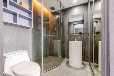 a bathroom with a toilet and a glass shower at CityGate by Villacarte in Kamala Beach