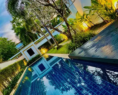 a swimming pool in front of a house at White Lotus by Oxygen at Bang Tao Beach in Ban Thalat Choeng Thale