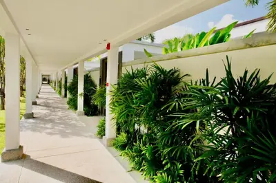 a corridor of a building with green plants at White Lotus by Oxygen at Bang Tao Beach in Ban Thalat Choeng Thale