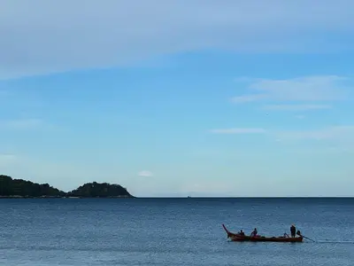a group of people in a boat in the water at Phuket Leelavadee Hua Ting Resort in Patong Beach